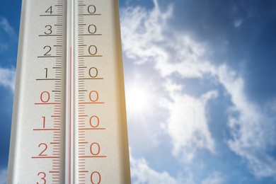 Image of Thermometer and blue sky with clouds on sunny day, low angle view. Space for text