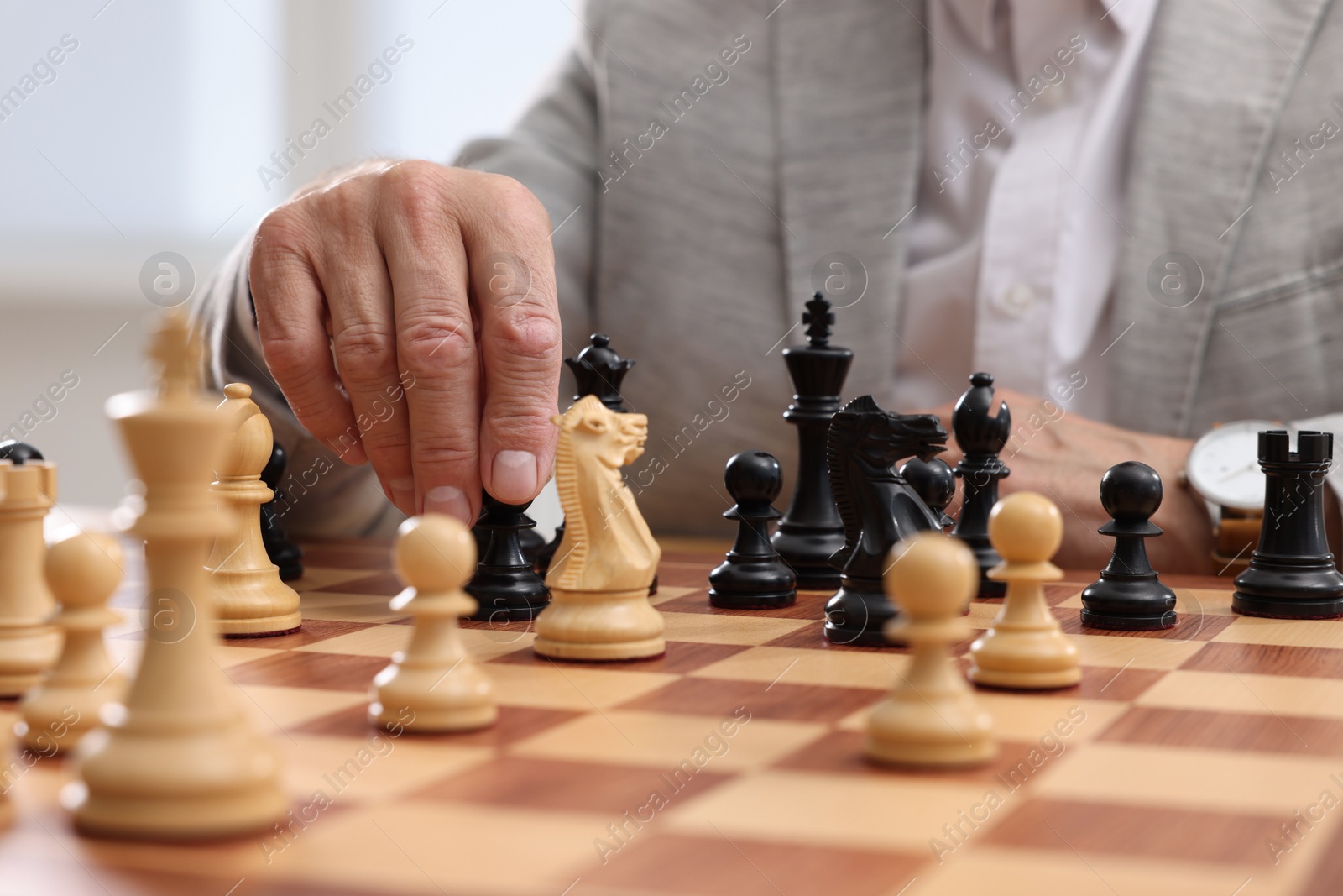 Photo of Man playing chess during tournament at chessboard, closeup