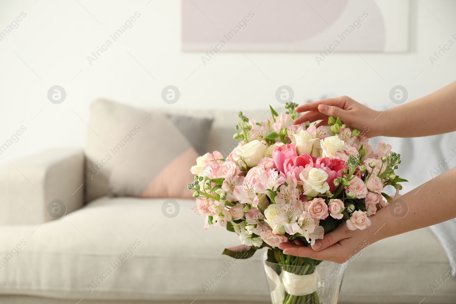 Photo of Woman with beautiful bouquet of fresh flowers at home, closeup. Space for text