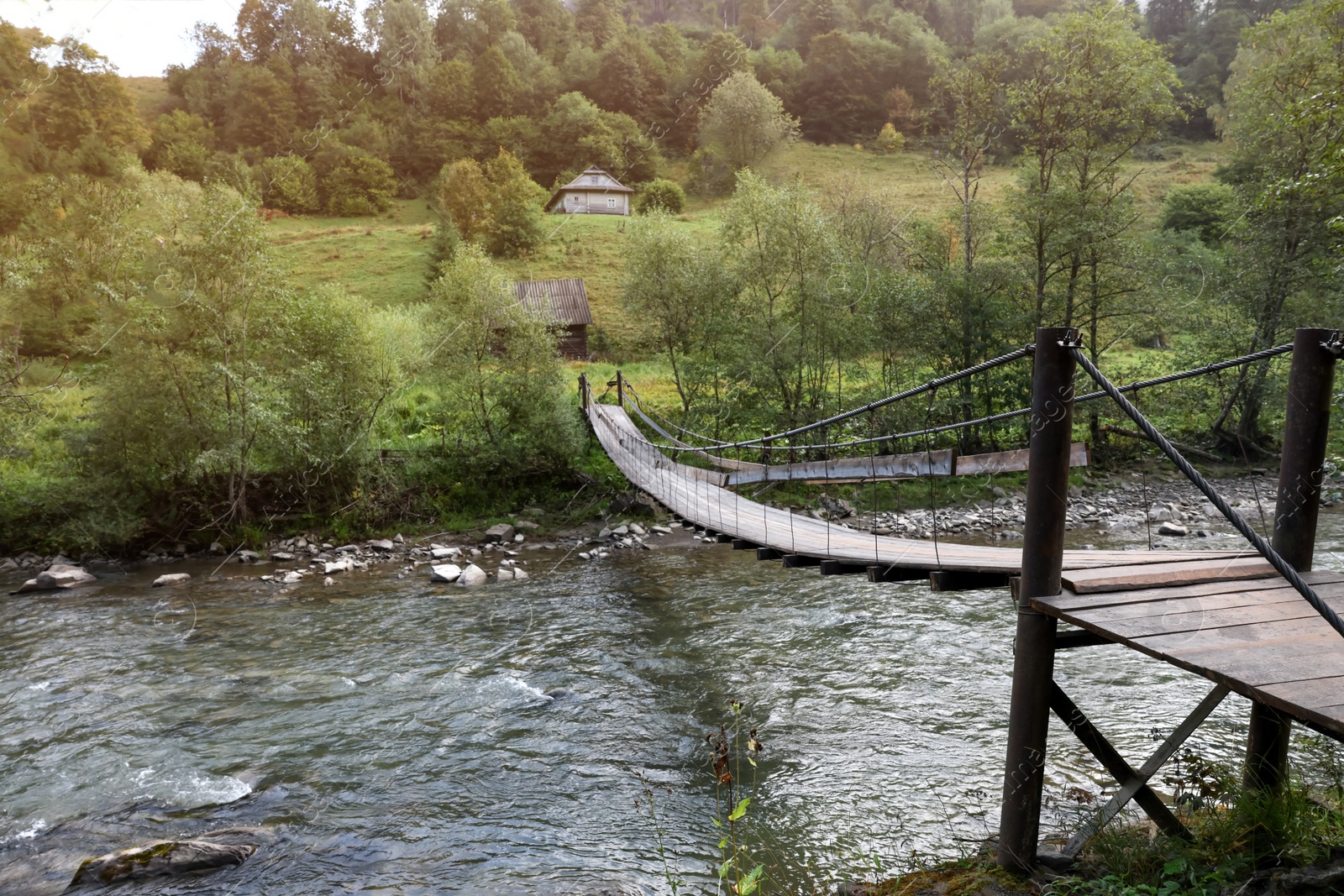 Photo of Beautiful view of wooden bridge over river in morning