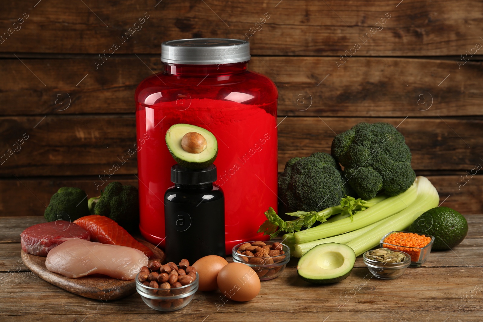 Photo of Set of products rich in amino acids and supplements on wooden table