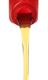 Photo of Pouring motor oil from red container isolated on white