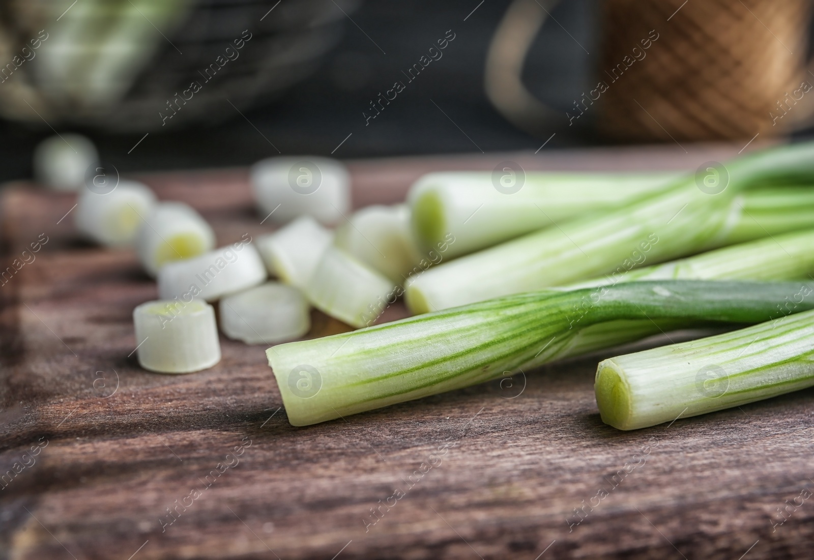 Photo of Wooden board with fresh green onion, closeup