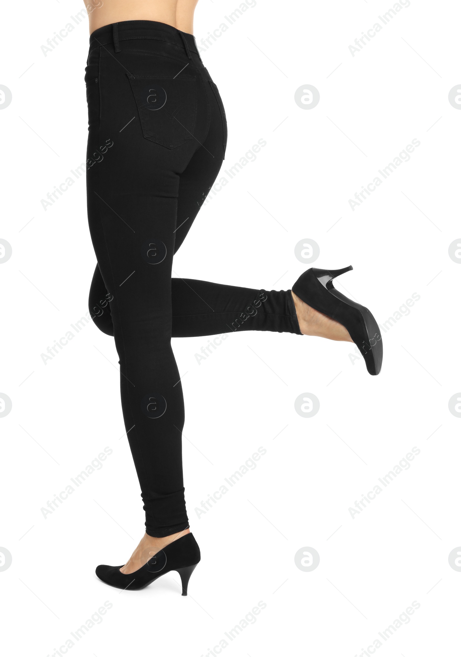 Photo of Woman wearing stylish black jeans and high heels shoes on white background, closeup