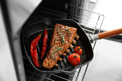 Photo of Delicious roasted ribs on pan in oven