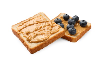 Photo of Delicious toasts with peanut butter and blueberries isolated on white