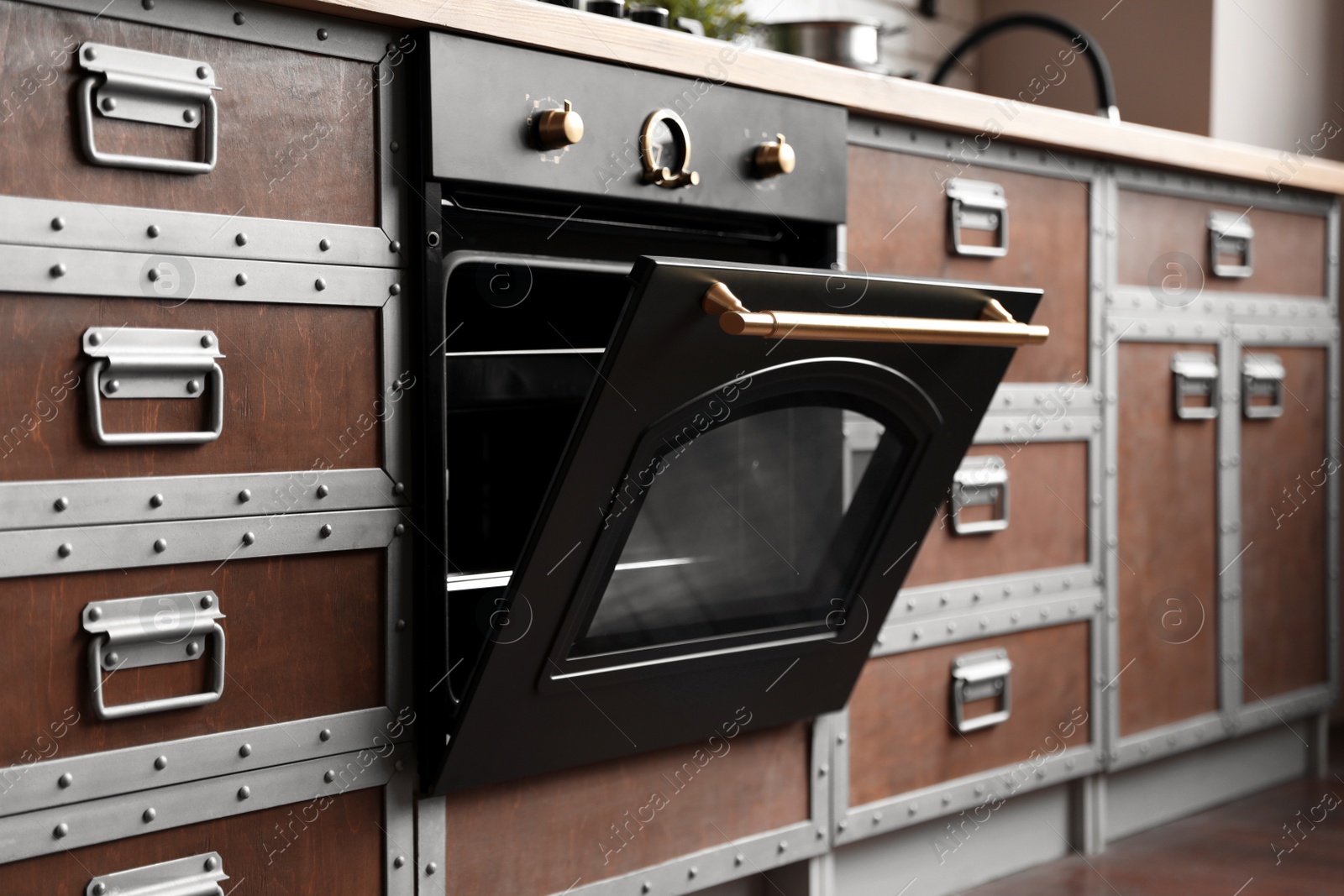 Photo of New modern oven in stylish kitchen. Cooking appliance