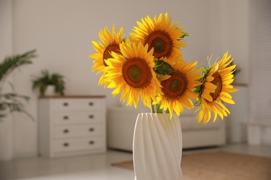 Beautiful bouquet of sunflowers in vase at home, closeup