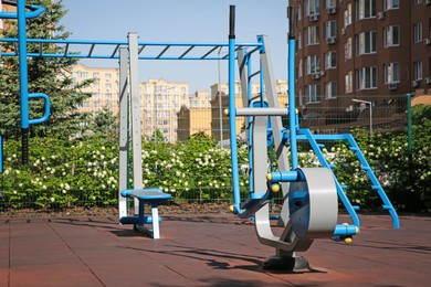 Photo of Empty outdoor gym with air walker and monkey bars in residential area