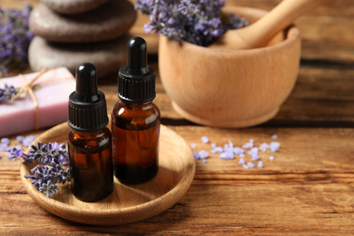 Photo of Cosmetic products and lavender flowers on wooden table
