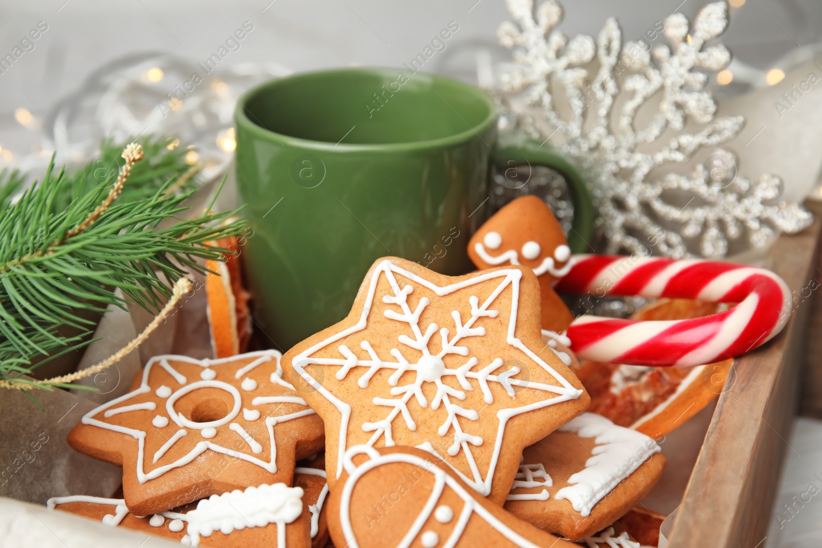 Photo of Crate with tasty homemade Christmas cookies and cup of coffee, closeup