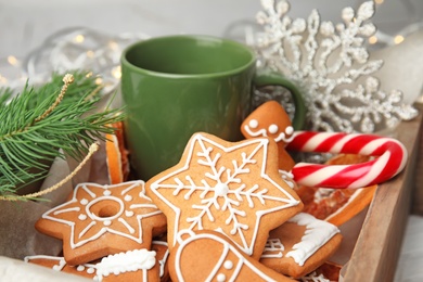 Crate with tasty homemade Christmas cookies and cup of coffee, closeup