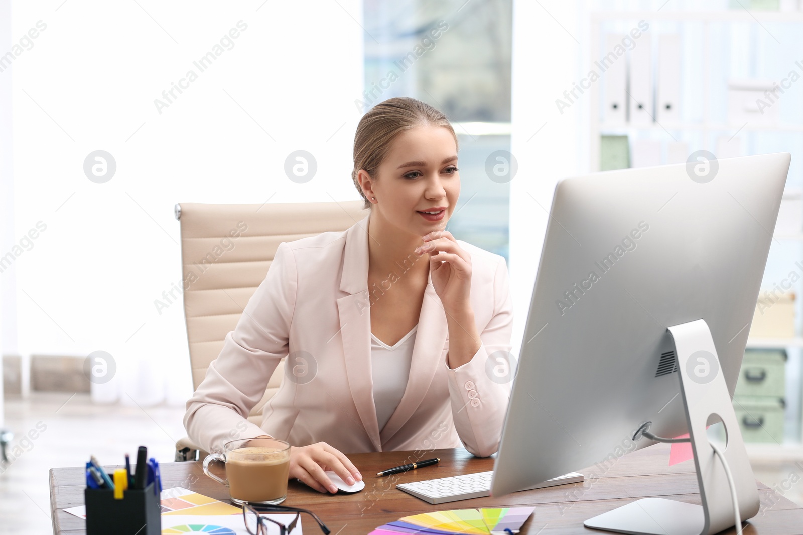 Photo of Female designer working at desk in office