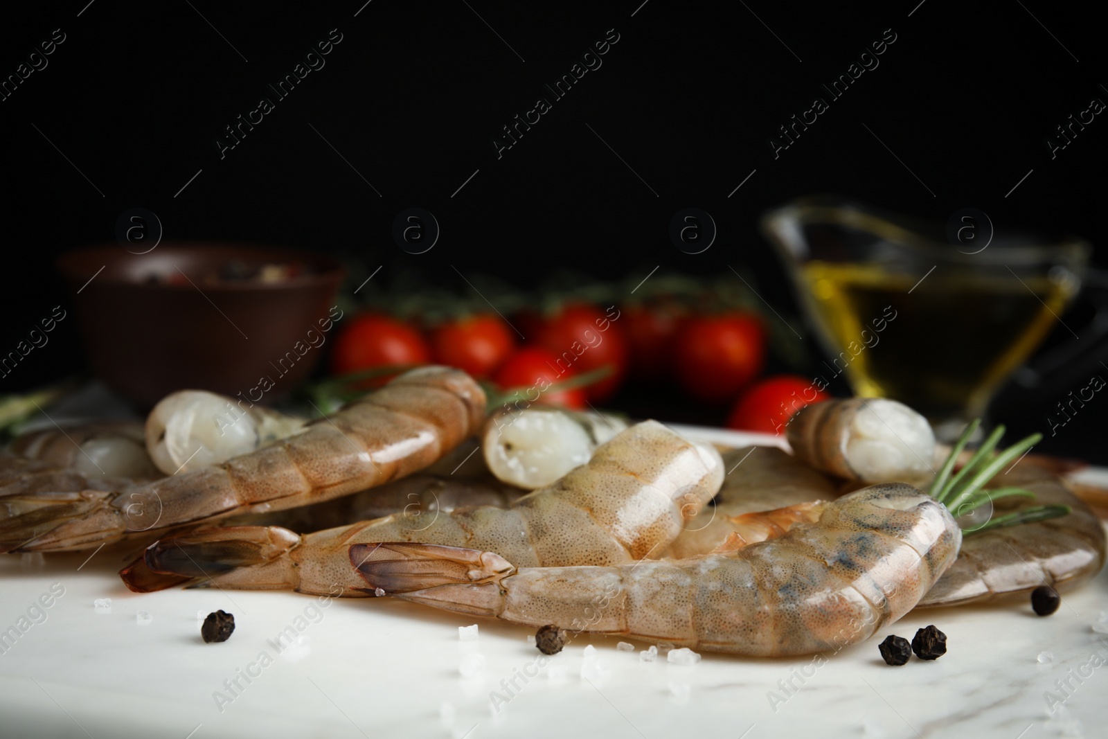 Photo of Fresh raw shrimps on marble board, closeup 