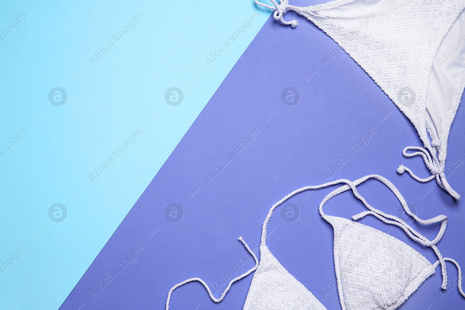 Photo of Stylish bikini and space for text on color background, flat lay
