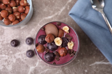 Photo of Flat lay composition with glass of tasty acai smoothie on gray table