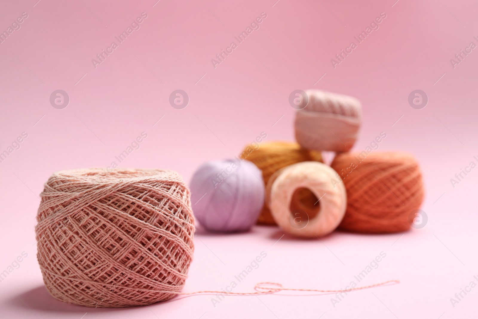 Photo of Clews of knitting threads on color background, space for text. Sewing stuff