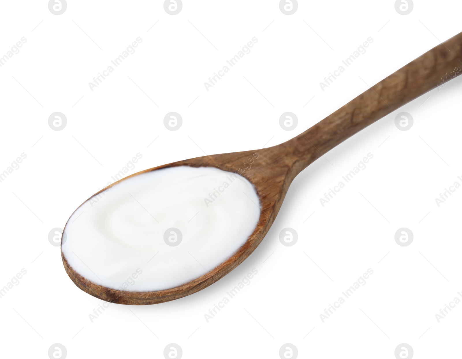 Photo of Delicious natural yogurt in wooden spoon isolated on white