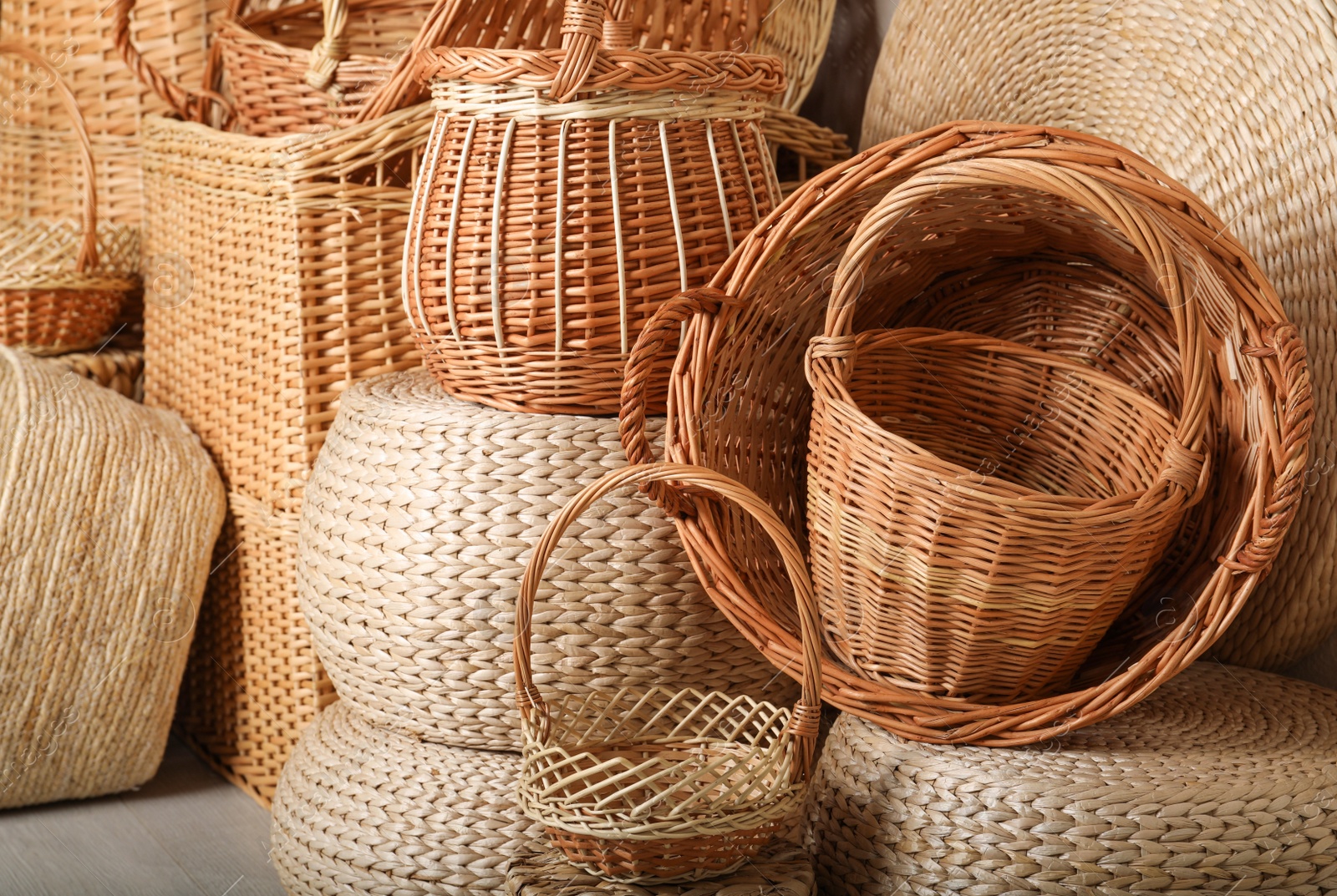 Photo of Many different wicker baskets made of natural material as background, closeup