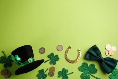 Photo of Leprechaun's hat and St. Patrick's day decor on green background, flat lay. Space for text