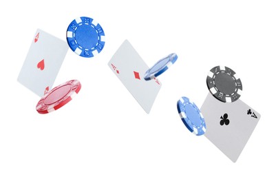 Image of Casino chips and playing cards falling on white background