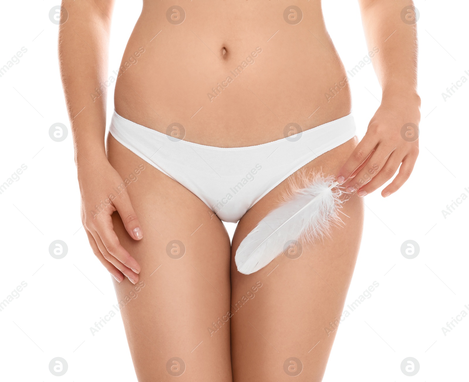 Photo of Woman with feather showing smooth skin on white background, closeup. Brazilian bikini epilation