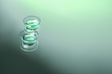 Photo of Contact lenses on color background