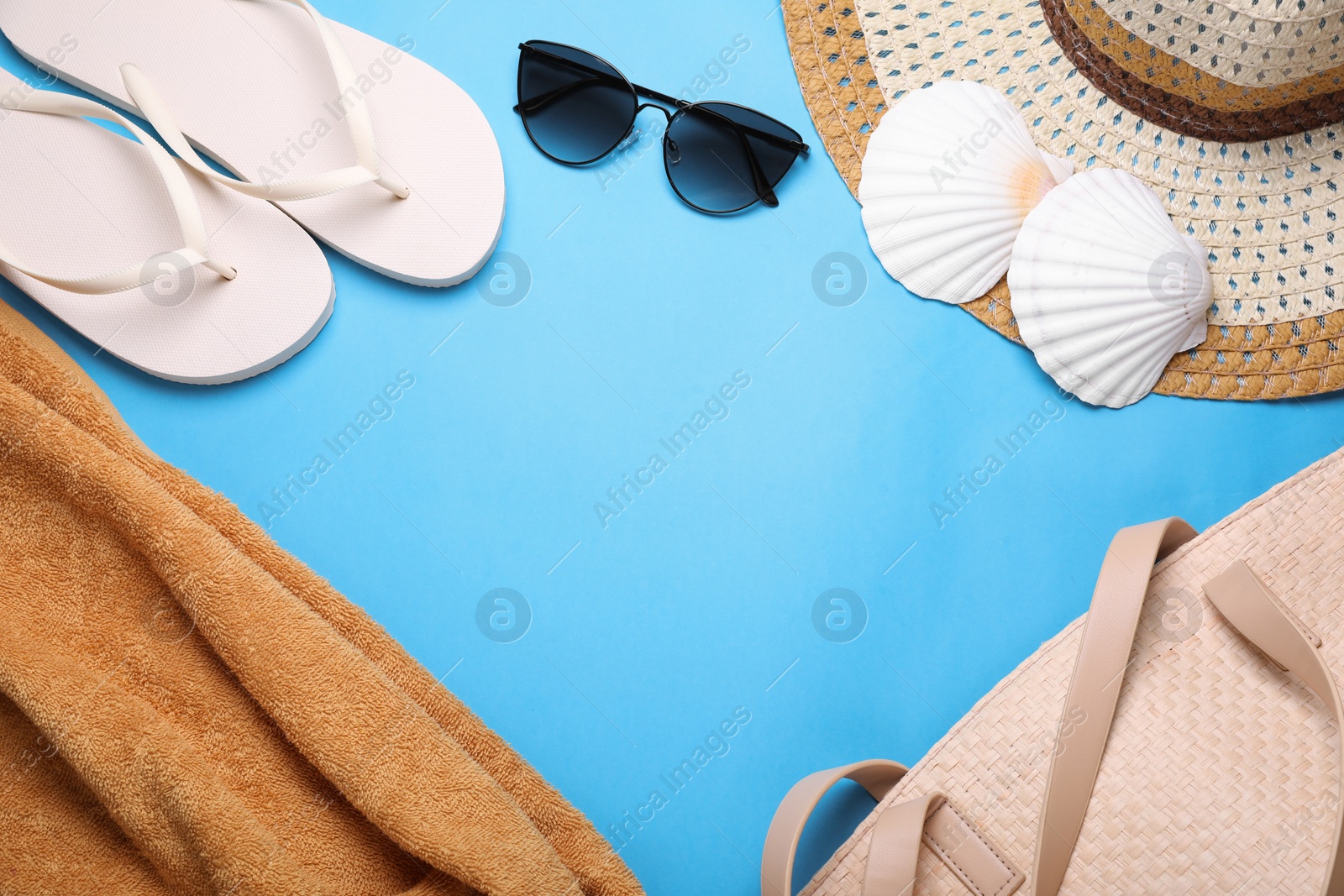 Photo of Flat lay composition with flip flops on light blue background. Space for text