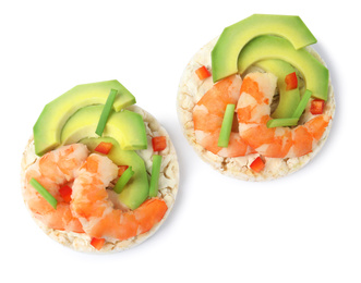 Photo of Puffed rice cakes with shrimps and avocado isolated on white, top view
