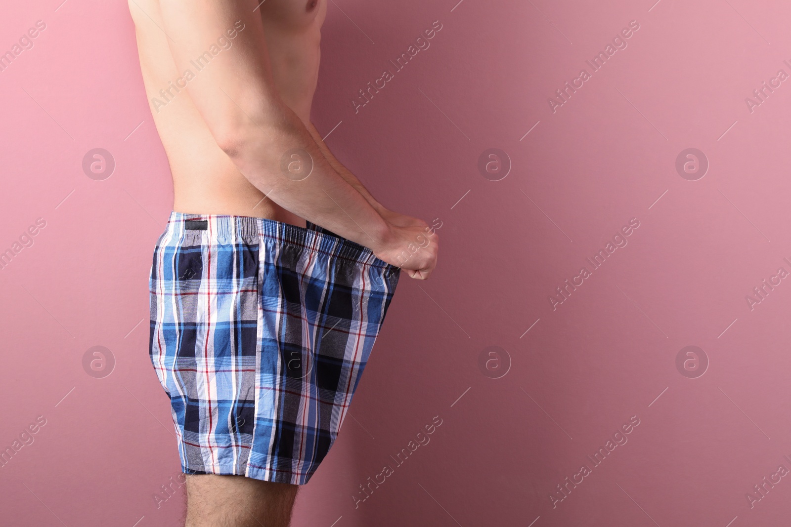 Photo of Young man with urological problems on color background