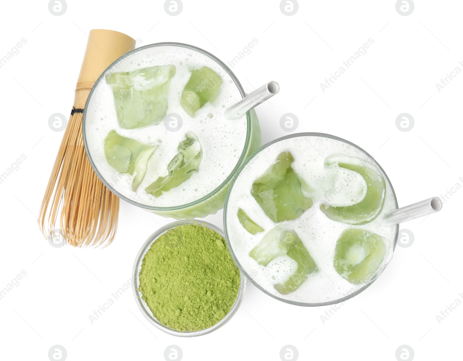 Photo of Glasses of tasty iced matcha latte, bamboo whisk and powder isolated on white, top view