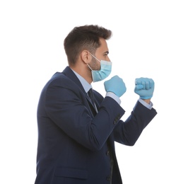 Photo of Businessman with protective mask and gloves in fighting pose on white background. Strong immunity concept