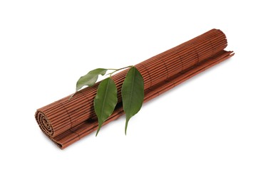Photo of Rolled sushi mat made of bamboo and leaves on white background