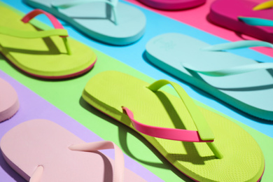 Photo of Composition with flip flops on color background, closeup. Beach objects