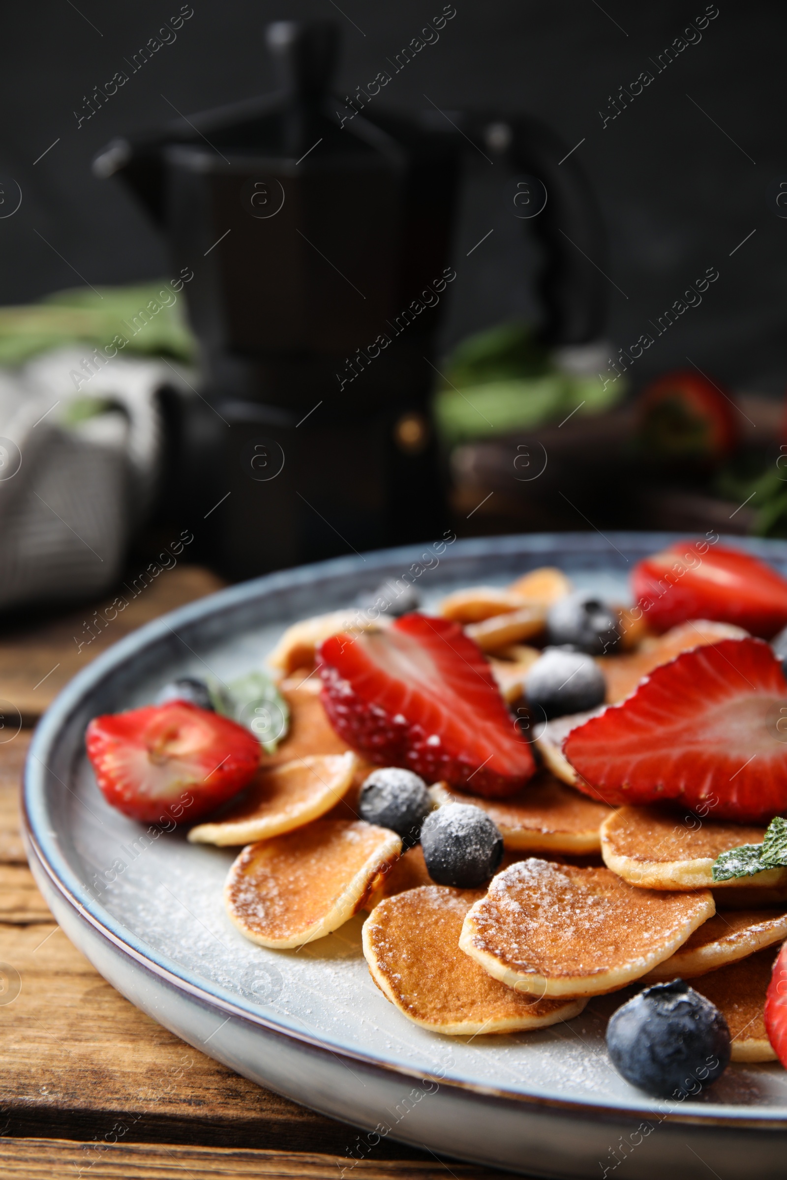 Photo of Cereal pancakes with berries on wooden table