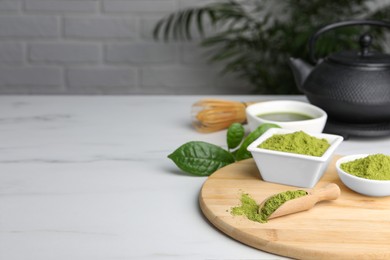 Photo of Green matcha powder on white table indoors, space for text