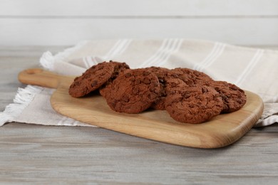 Delicious chocolate chip cookies on light wooden table