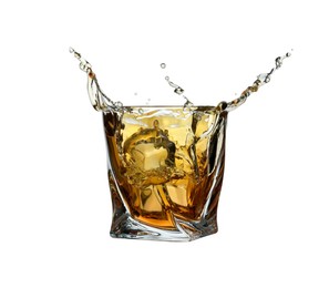 Photo of Whiskey splashing in glass isolated on white