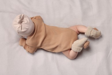 Photo of Newborn baby lying on blanket, top view