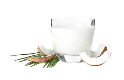 Glass of coconut milk and nuts on white background