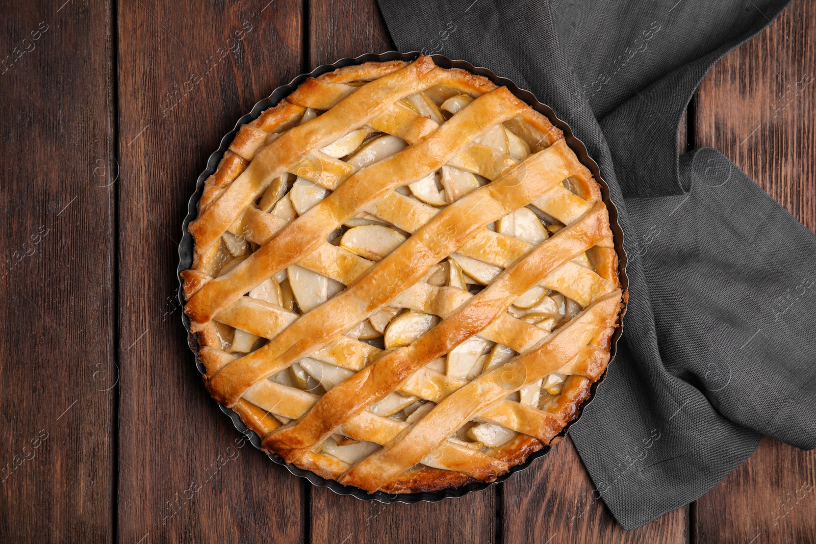 Photo of Delicious traditional apple pie on wooden table, top view