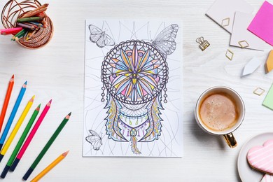 Photo of Antistress coloring page, pencils and coffee on white wooden table, flat lay