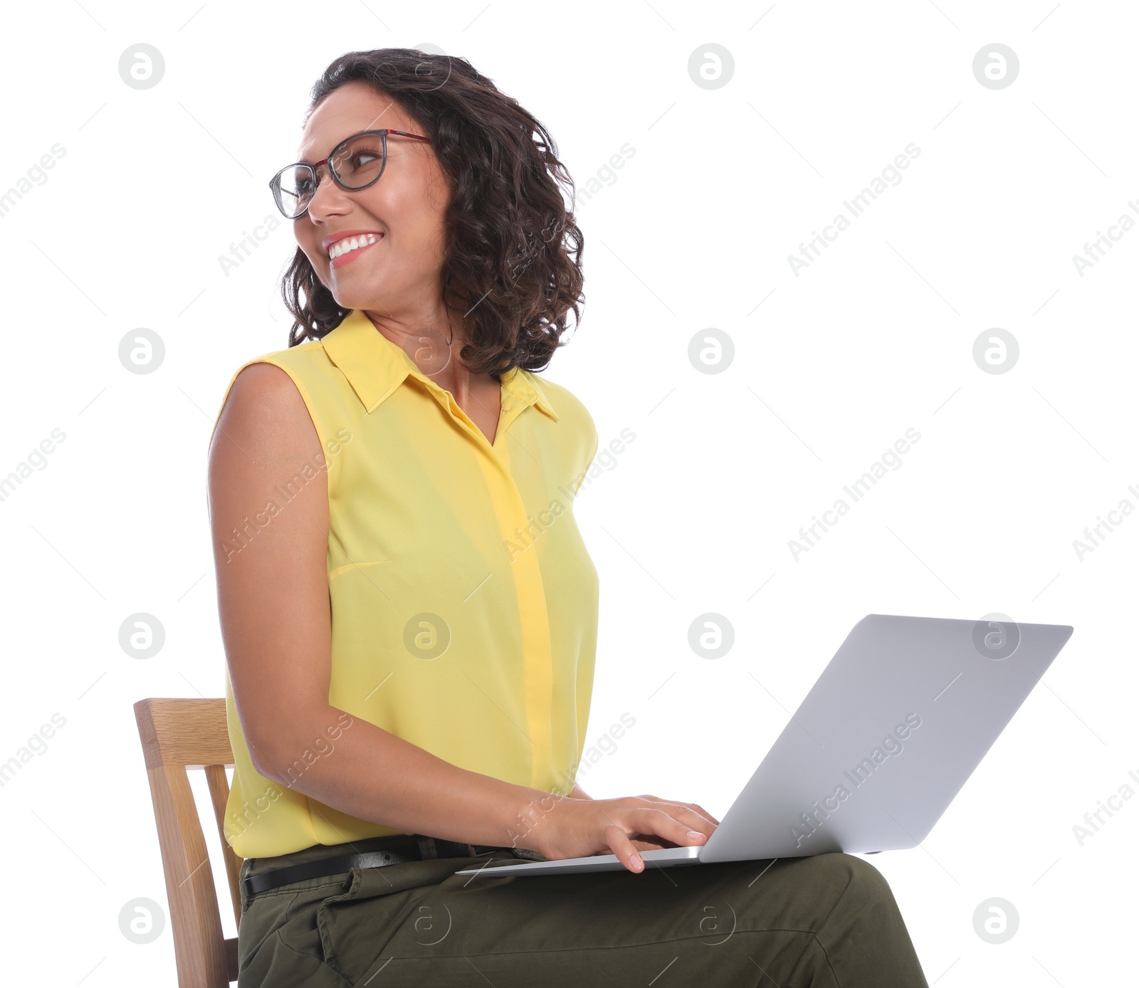 Photo of Happy young woman sitting on chair and working with laptop on white background