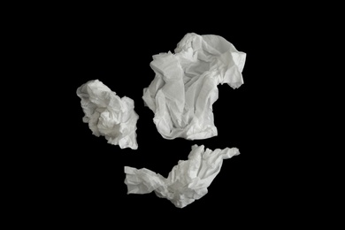 Used paper tissues on black background, flat lay