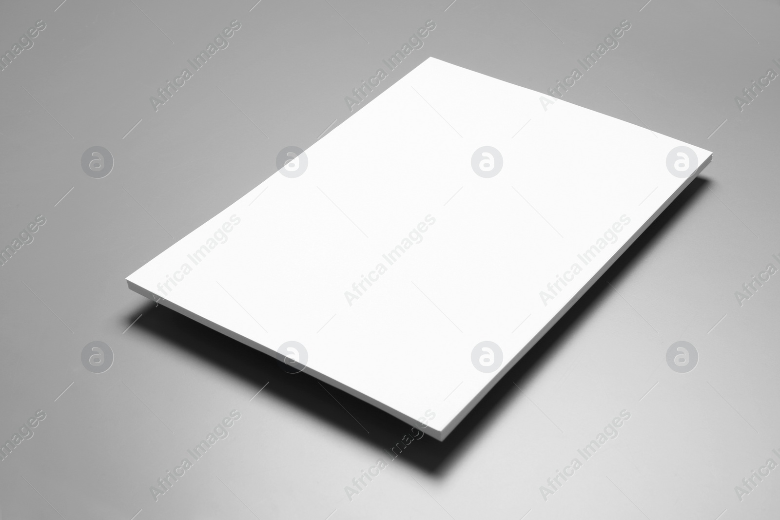 Photo of Blank paper sheets for brochure on grey background. Mock up