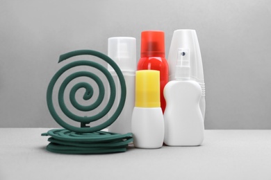 Set of different insect repellents on grey background