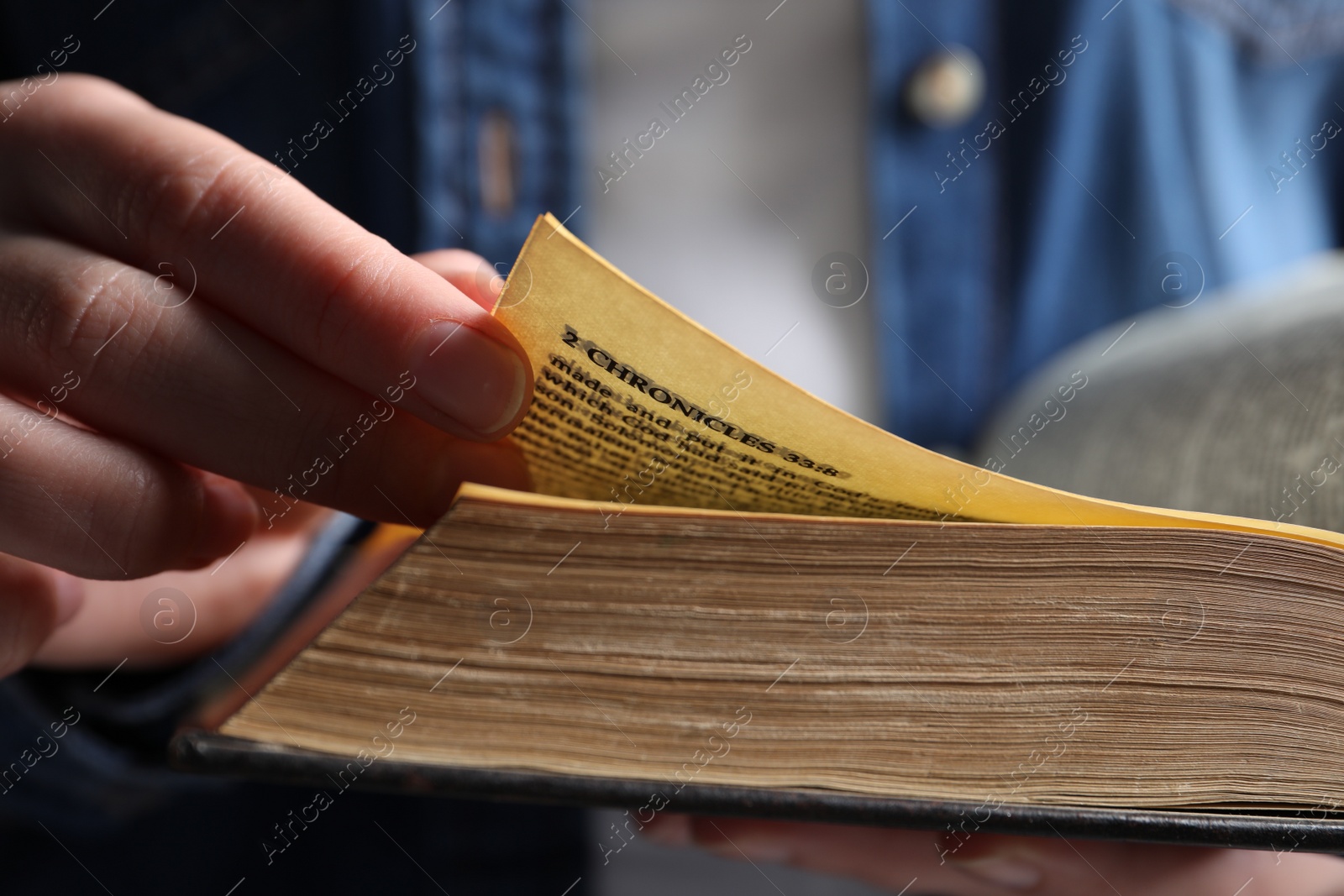 Photo of Woman reading old holy Bible, closeup view