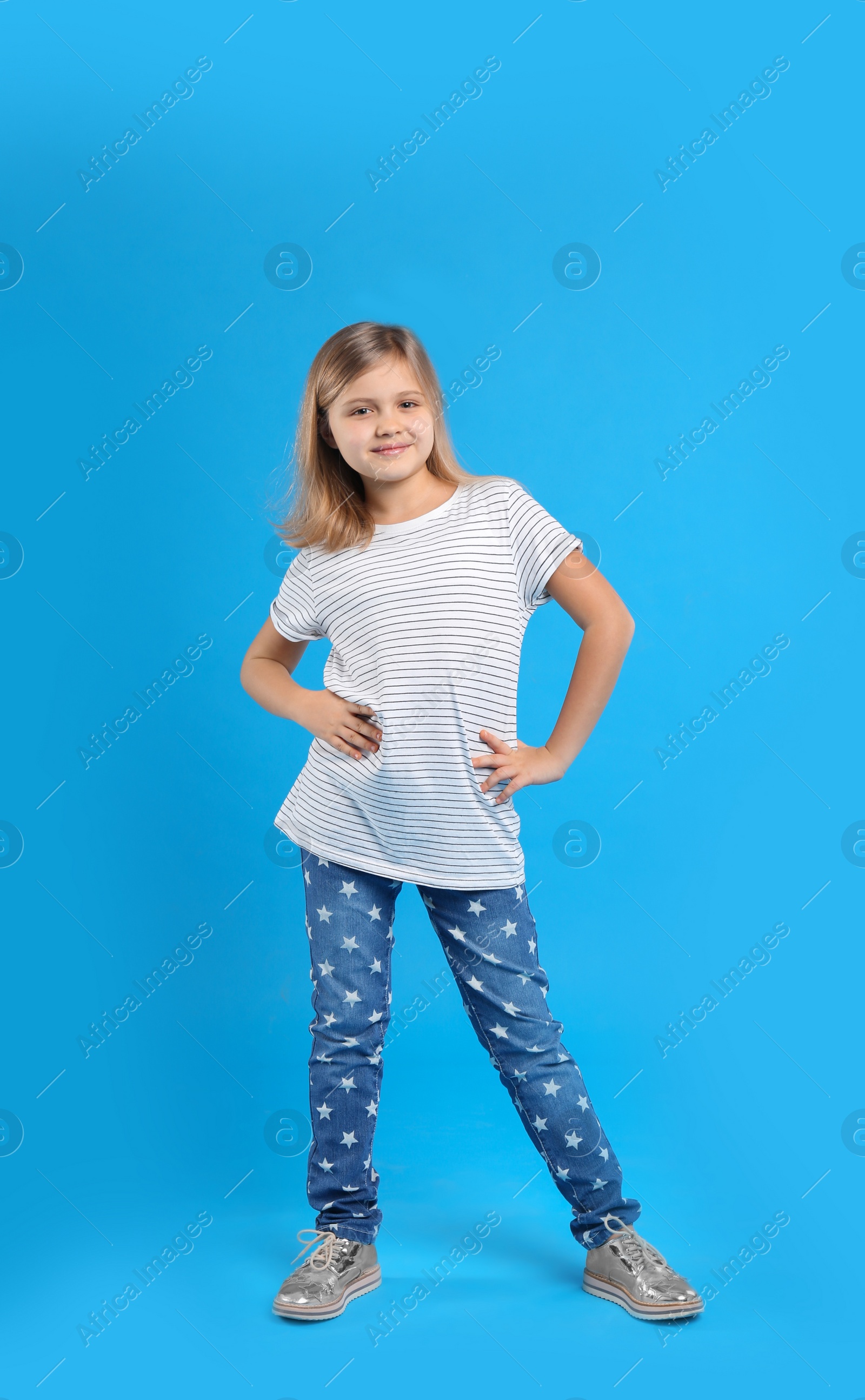 Photo of Cute little girl on light blue background