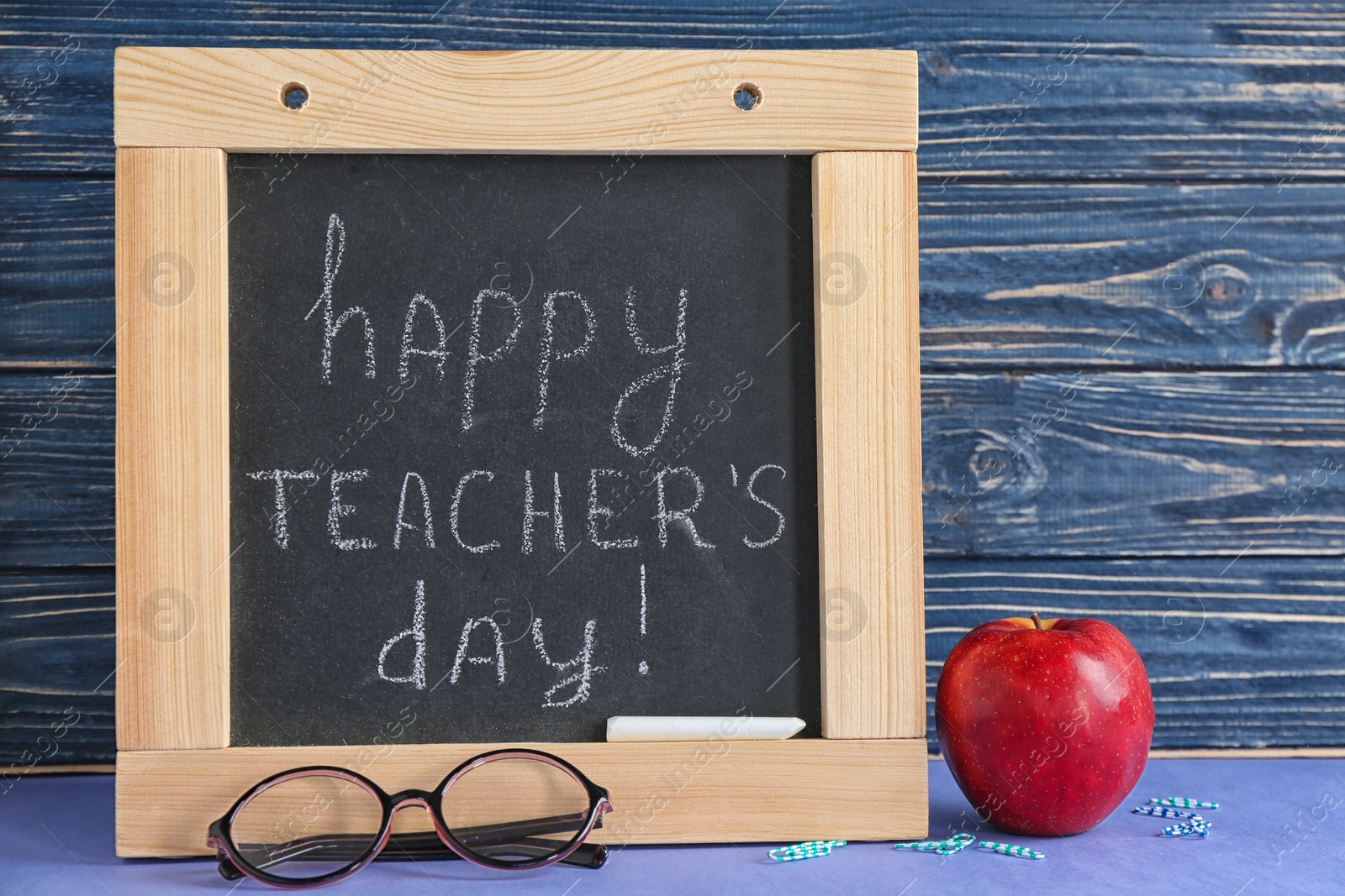 Photo of Composition with small chalkboard for Teacher's day on table