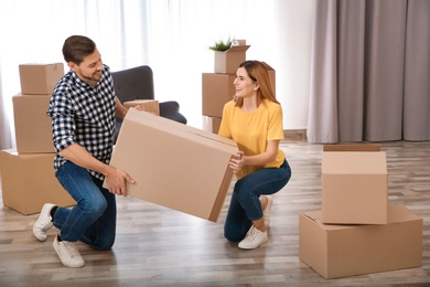 Photo of Couple with moving box in their new house